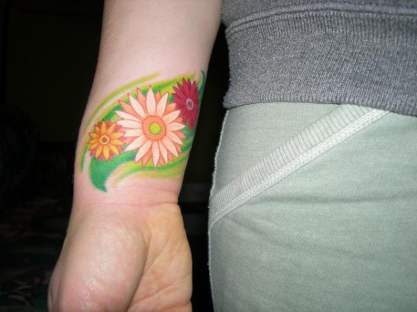 Colorful Daisy Flowers Tattoo On Right Wrist