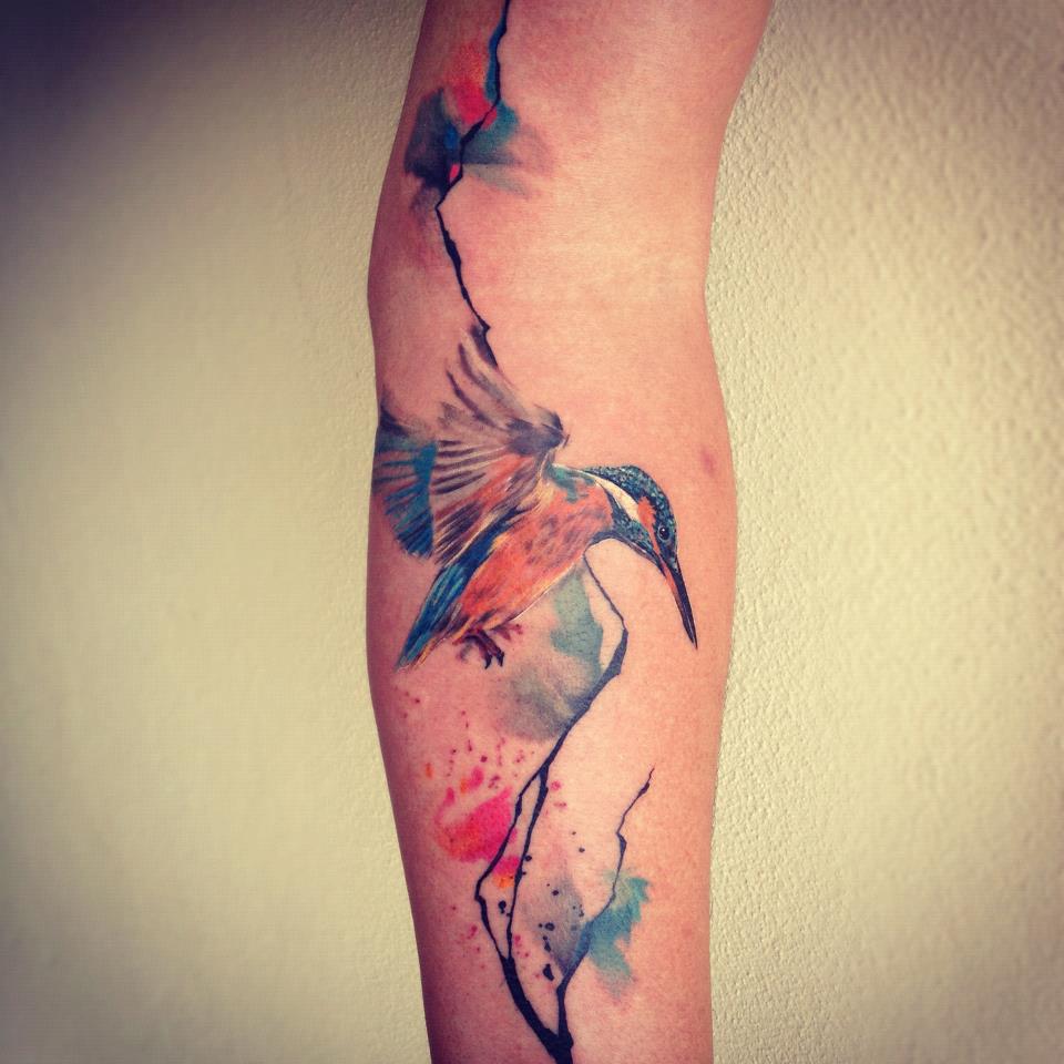 Colorful Flying Hummingbird Tattoo On Forearm