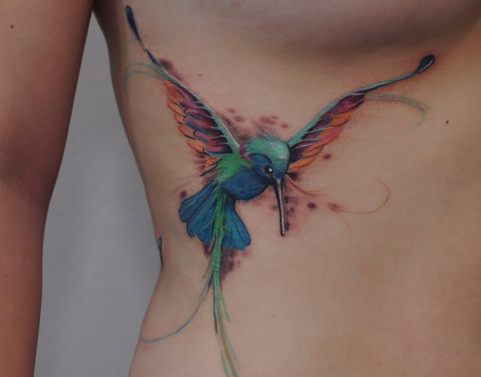 Colorful Hummingbird Tattoo On Girl Side Rib