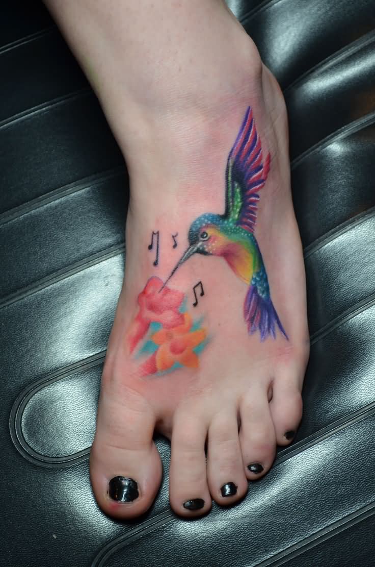 Colorful Hummingbird With Flowers And Music Knots Tattoo On Girl Foot