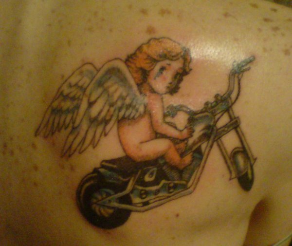 Crying Cupid Cherub On Bike Tattoo On Right Back Shoulder