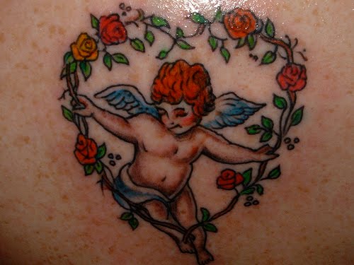 Cute Cupid Cherub In Flower Frame Tattoo Design
