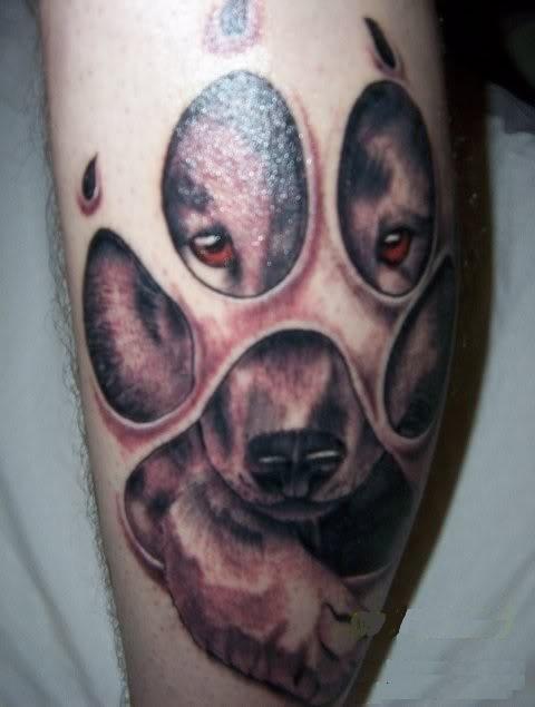 Dog Face In Paw Print Tattoo Design For Leg