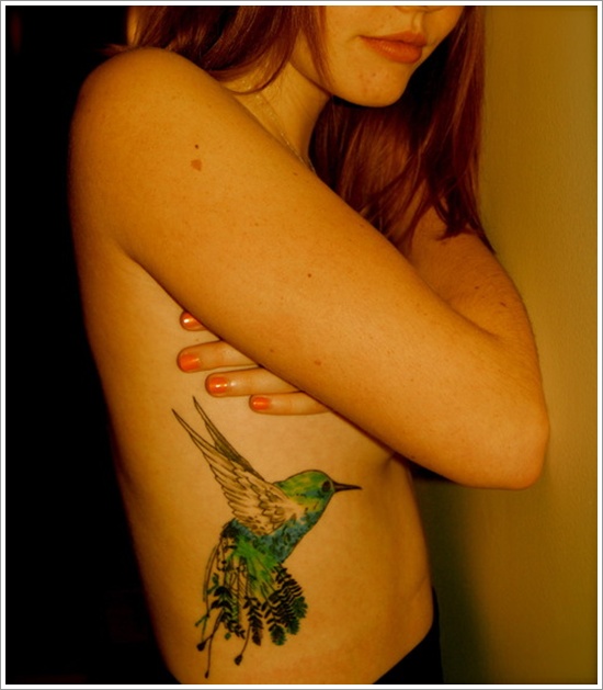 Flying Hummingbird Tattoo On Girl Side Rib