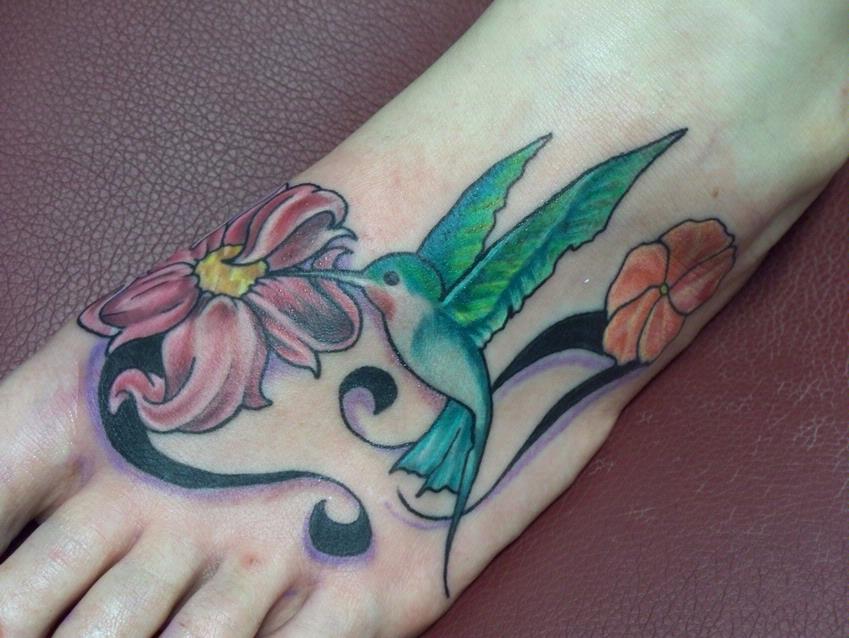 Green Ink Hummingbird With Flower Tattoo On Foot