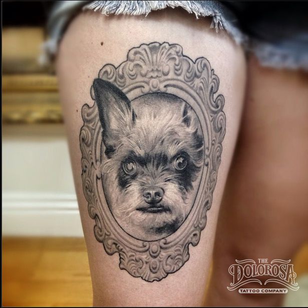 Grey Ink Cute Dog Face In Frame Tattoo On Girl Thigh By Alex Garcia