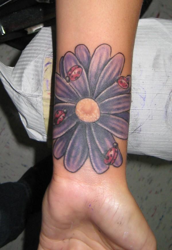 Ladybirds On Purple Daisy Tattoo On Wrist
