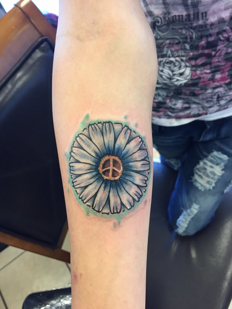 Peace Daisy Flower Tattoo On Forearm