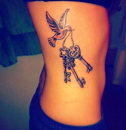 Rosary Keys In Flying Bird Beak Tattoo On Side Rib