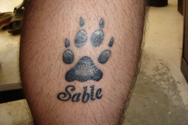 Sable - Black Paw Print Tattoo Design For Leg