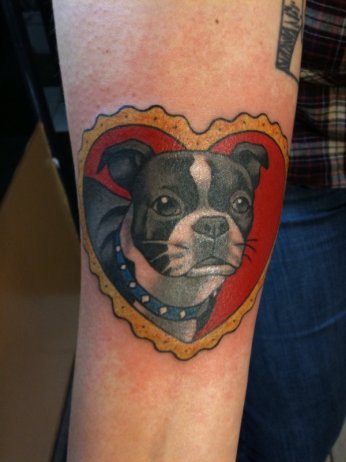 Traditional Dog In Heart Shape Frame Tattoo On Forearm
