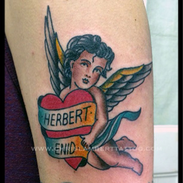 Traditional Heart With Banner In Cupid Cherub Hand Tattoo Design For Half Sleeve