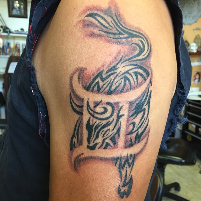 Tribal Taurus And Gemini Tattoo On Left Shoulder