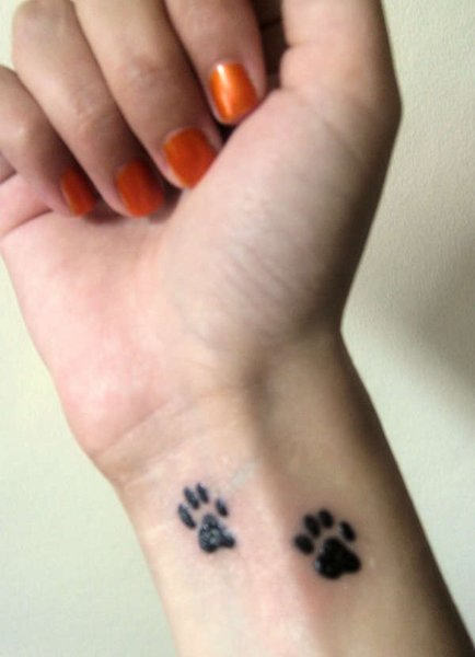 Two Dog Paw Prints Tattoo On Girl Wrist