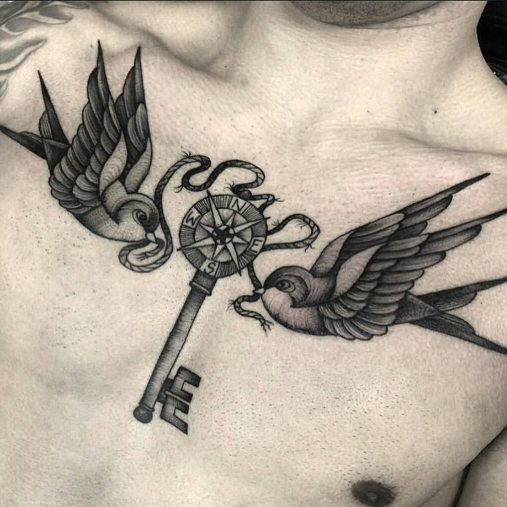 Two Flying Birds With Key Tattoo On Man Chest