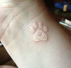 White Ink Heart In Dog Paw Print Tattoo Design For Wrist