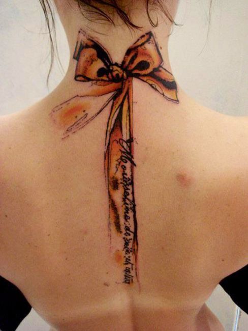 Attractive Ribbon Bow Tattoo On Upper Back