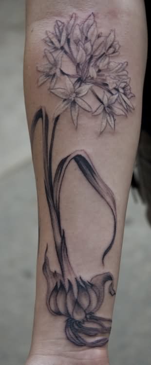 Black And Grey Garlic With Flowers Tattoo On Forearm