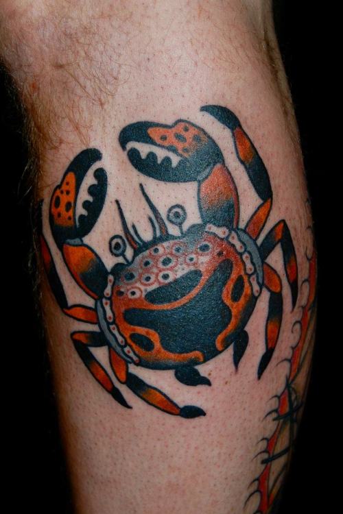 Black And Orange Ink Crab Tattoo On Leg