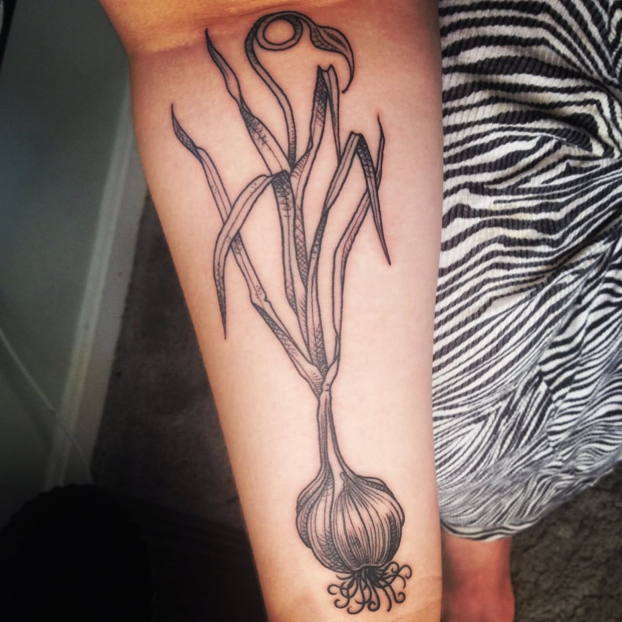 Black In Garlic Tattoo On Forearm
