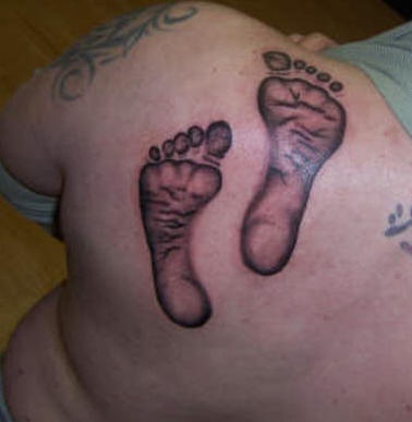 Black Ink Footprints Tattoo On Left Back Shoulder