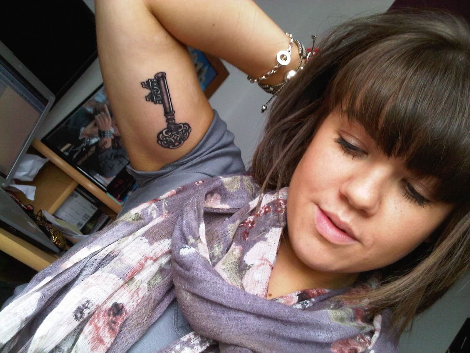 Black Ink Key Tattoo On Girl Right Bicep
