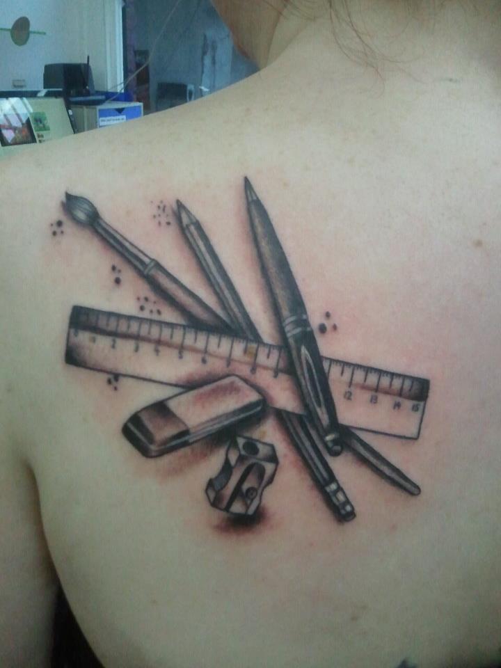 Black Ink Pencil With Pen, Scale And Brush Tattoo On Left Back Shoulder