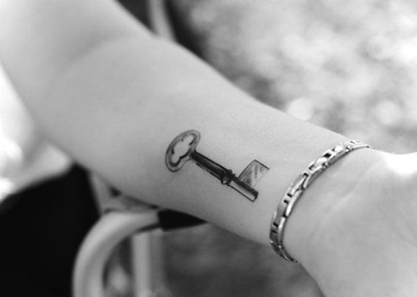 Black Ink Simple Key Tattoo Design For Forearm
