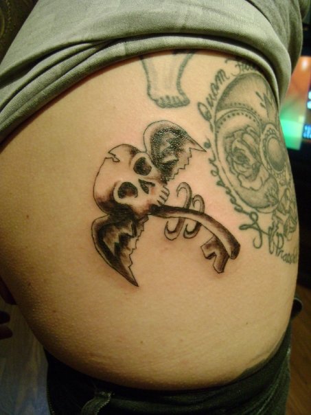 Black Ink Skull Key With Wings Tattoo Design For Side Rib