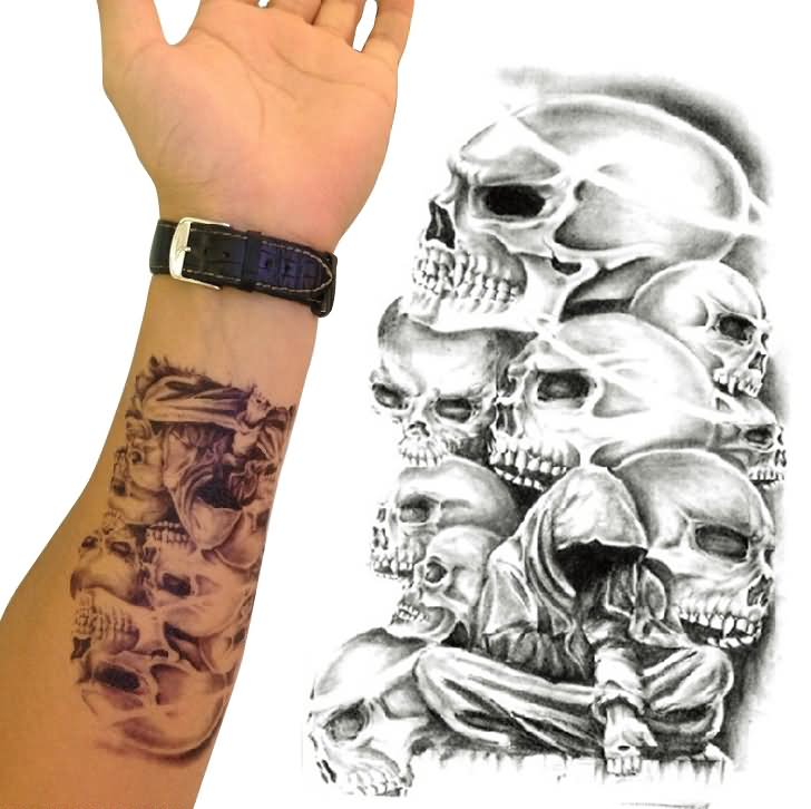 Black Ink Skulls Tattoo On Forearm