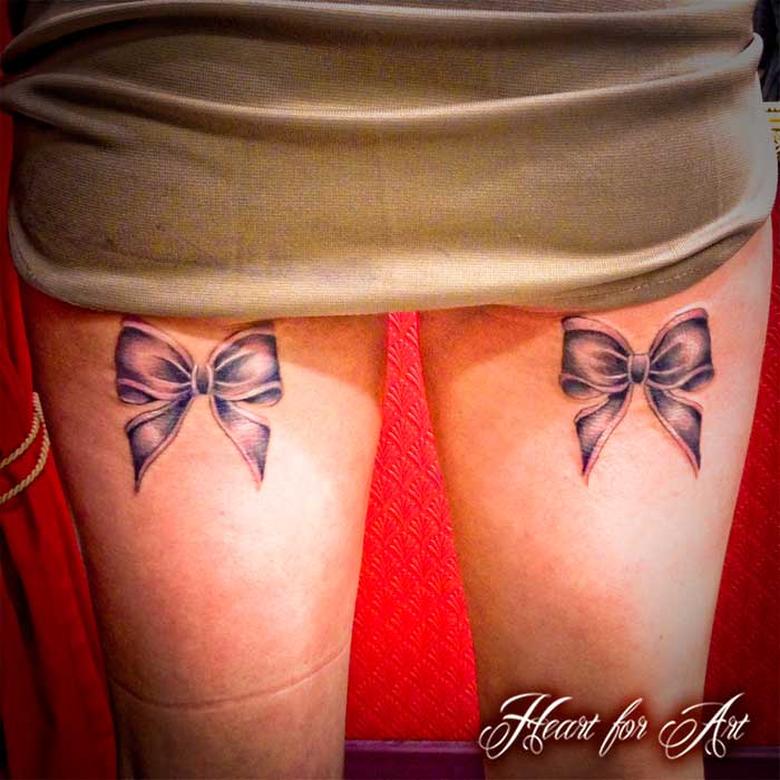 Black Ink Two Ribbon Bow Tattoo On Both Back Leg