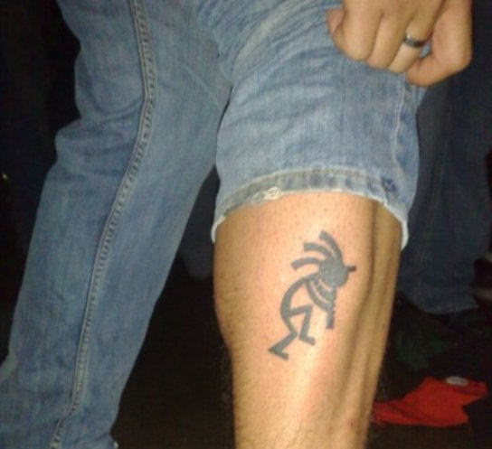 Black Kokopelli Tattoo On Leg