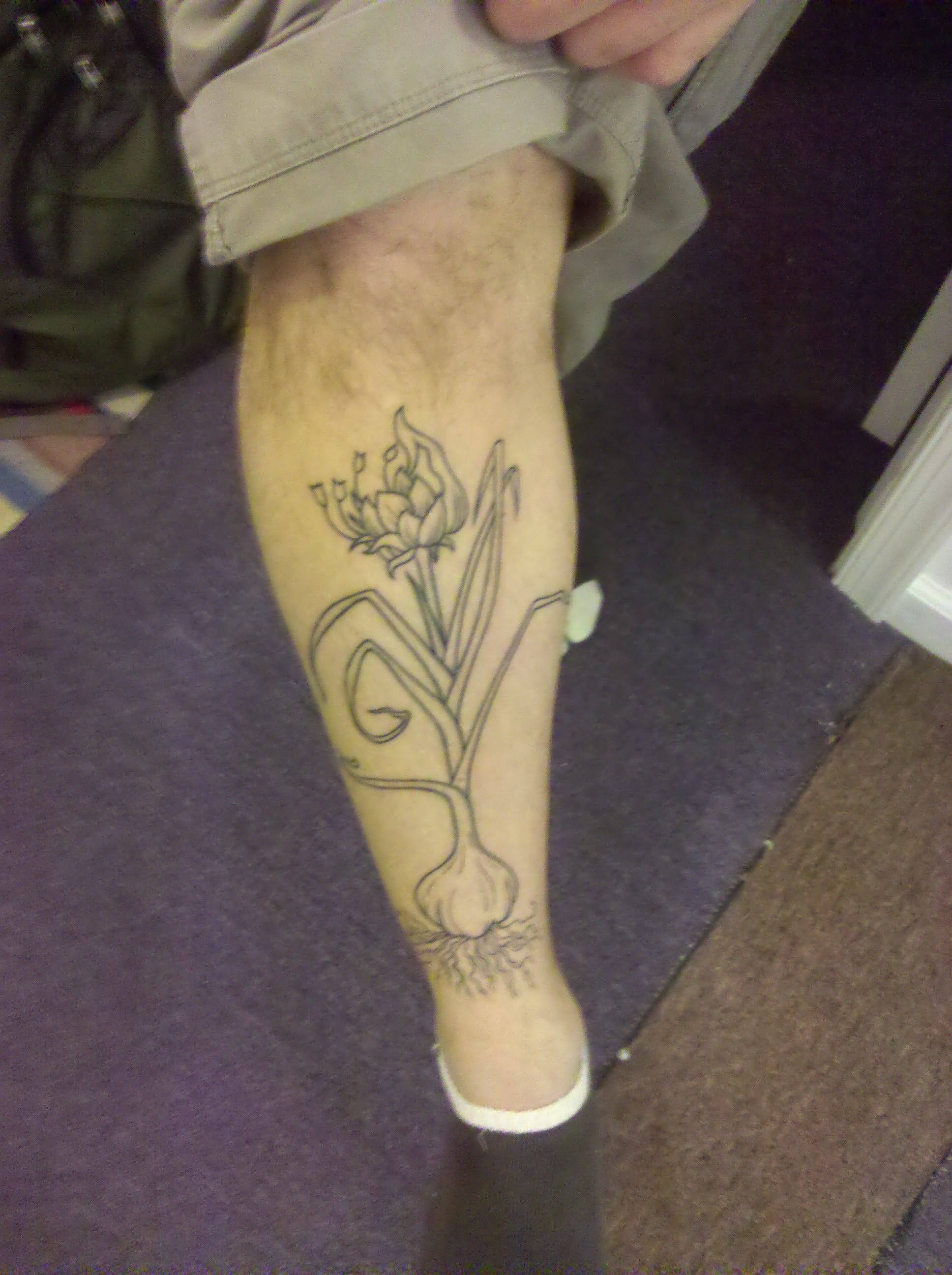 Black Outline Garlic With Flowers Tattoo On Leg