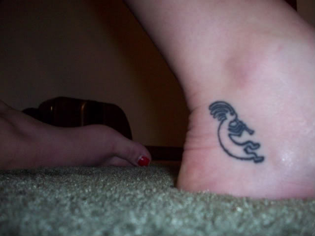 Black Outline Kokopelli Tattoo On Ankle