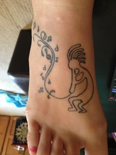 Black Outline Kokopelli Tattoo On Girl Foot
