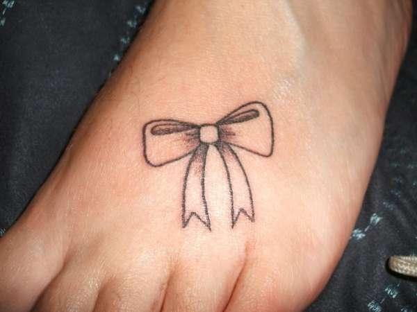 Black Outline Ribbon Bow Tattoo On Foot