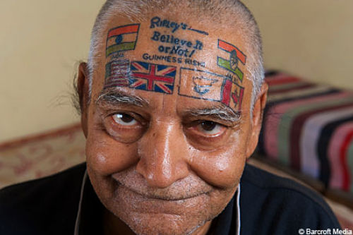 Colored Flags Tattoos On Guy Forehead