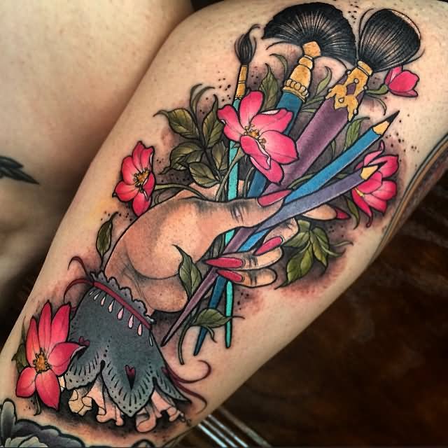 Colorful Paintbrush And Pencil In Hand Tattoo Design