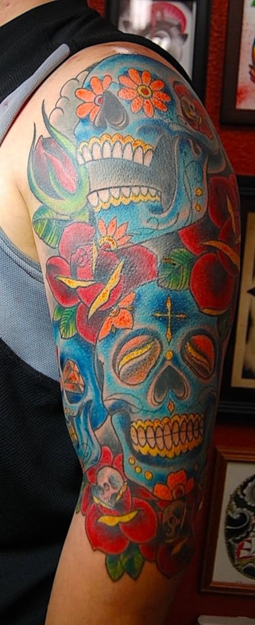 Colorful Two Dia De Los Muertos Skulls With Flowers Tattoo On Half Sleeve