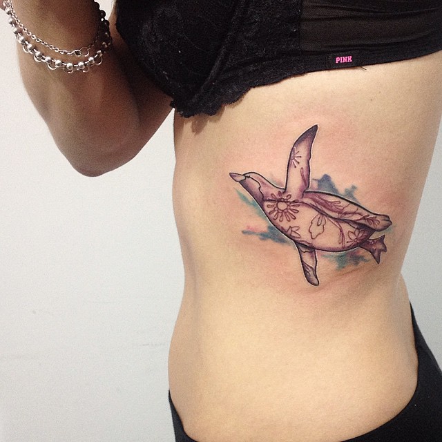 Flying Penguin Tattoo On Girl Side Rib