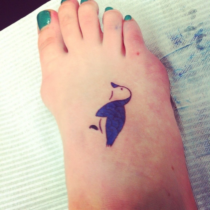 Girl With Penguin Tattoo On Foot