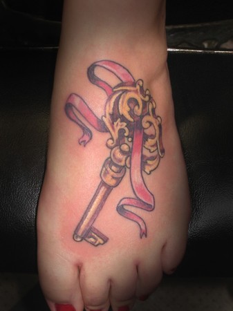 Key With Ribbon Tattoo On Girl Foot