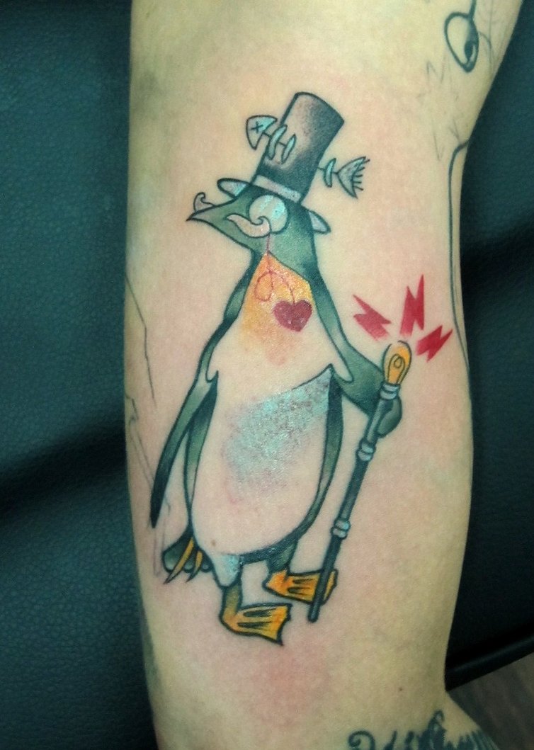 Mr. Penguin Tattoo On Bicep
