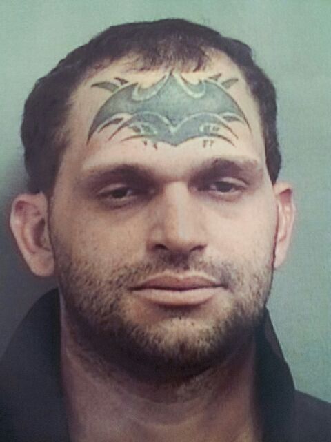 Nice Tribal Batman Tattoo On Forehead