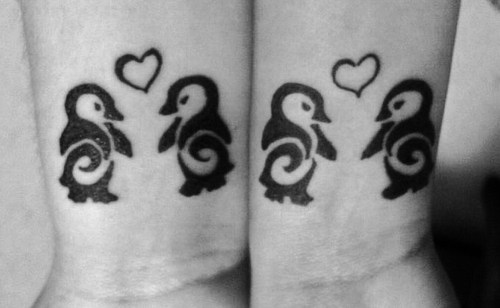 Outline Heart And Tribal Penguin Tattoos On Wrist