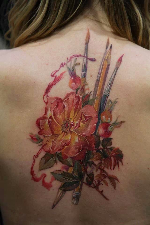Paintbrush And Pencil With Flower Tattoo On Girl Upper Back