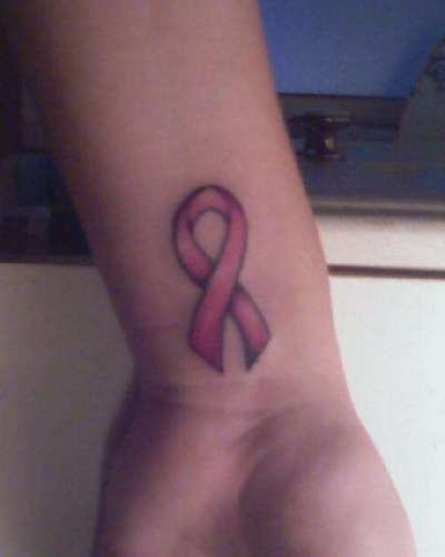 Pink Ink Cancer Ribbon Tattoo On Wrist