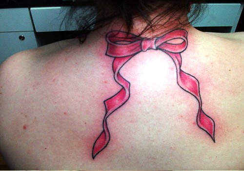 Pink Ink Ribbon Bow Tattoo On Upper Back