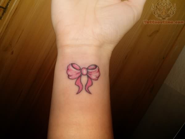 Pink Ink Ribbon Bow Tattoo On Wrist