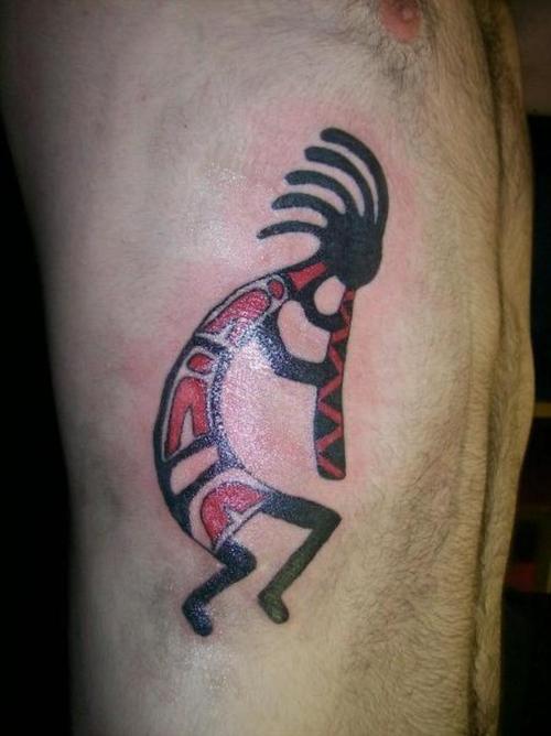 Red And Black Kokopelli Tattoo On Man Side Rib